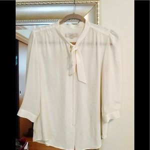 Cream colored Loft blouse with tie in front.